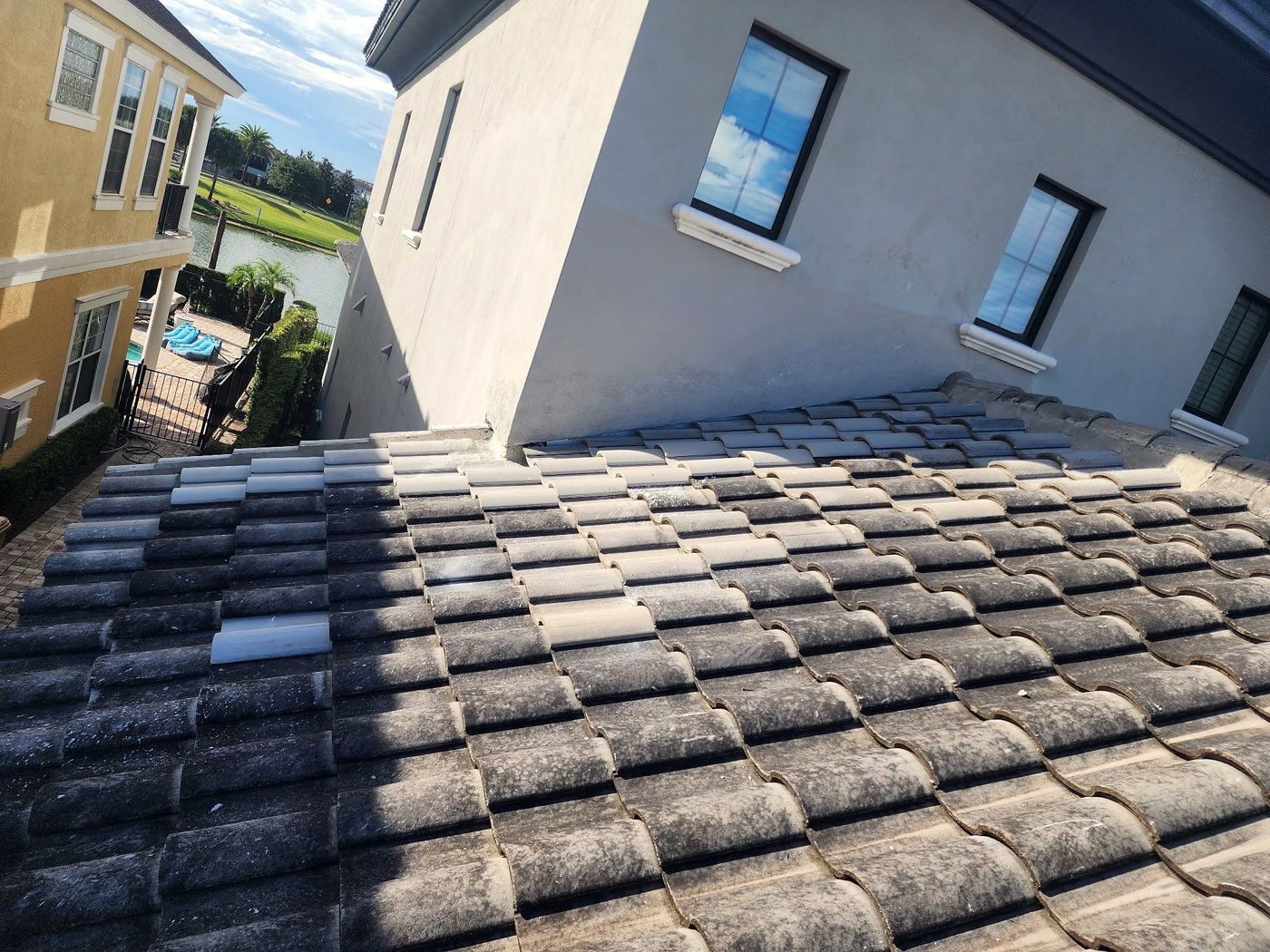 Tile roof after repair, with replaced tiles blending into the existing roof